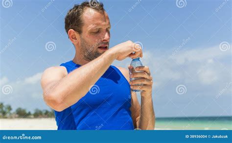 Man Drinking Water After Running At Beach Thirsty Sport Runner Stock