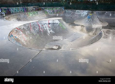 Wet Empty Skate Park With Sky Reflected In The Concrete Stock Photo Alamy