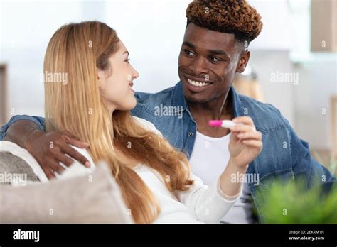 Happy Excited Couple Making Positive Pregnancy Test And Celebrating