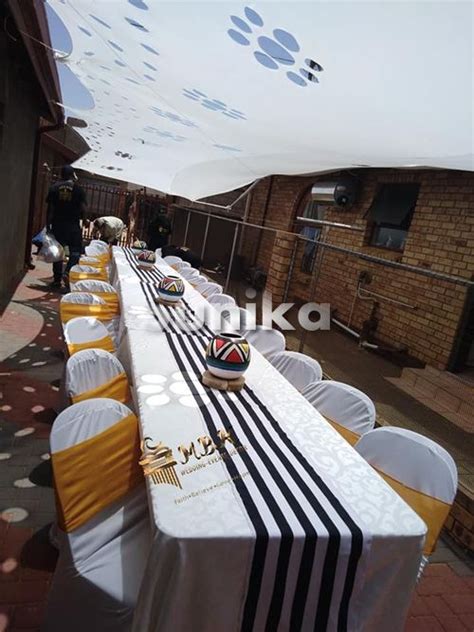 Long Tables With White And Black Tablecloths Are Lined Up On The Side