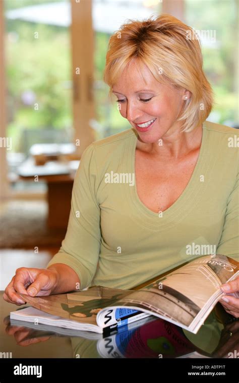 Mature Woman Reading Magazine Model Released Stock Photo Alamy