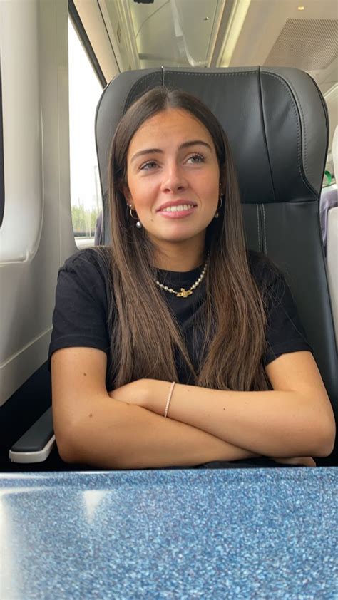 A Woman Sitting At A Table With Her Arms Crossed