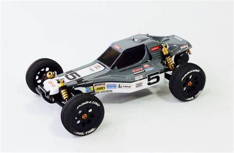 A Toy Car Is Shown On A White Surface With Black Tires And Wheels As