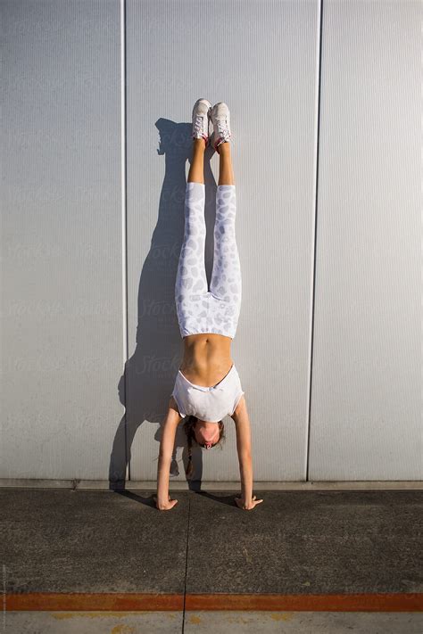 Girl Doing Handstand By Stocksy Contributor Michela Ravasio Stocksy