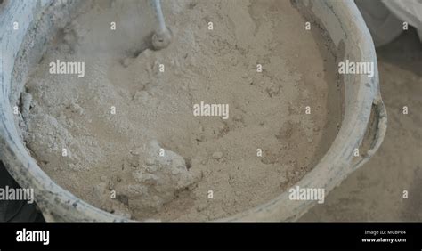 mixing concrete plaster with electric mixer, wide photo Stock Photo - Alamy