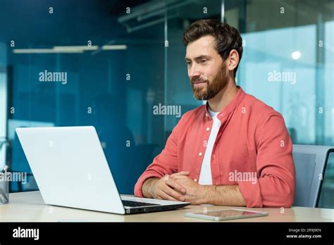 Mature Adult Businessman Working On Laptop Inside Office Programmer