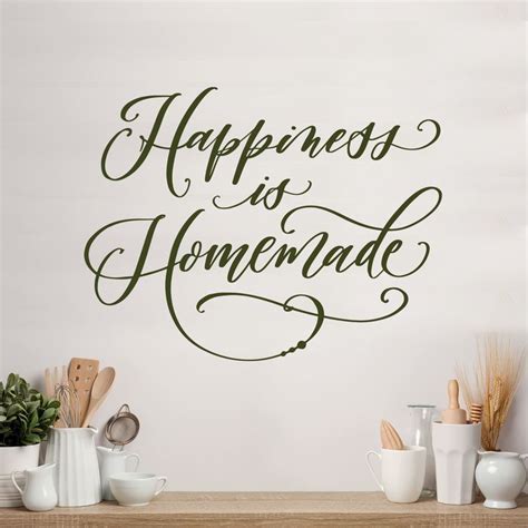 A Wall Decal That Says Happiness Is Homemade On The Side Of A Table