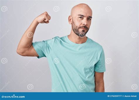 Middle Age Bald Man Standing Over White Background Strong Person Showing Arm Muscle Confident