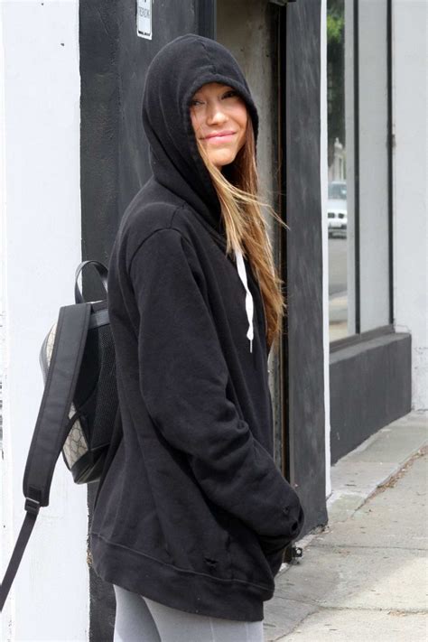 Alexis Ren Wears A Black Hoodie And Grey Leggings As She Arrives At