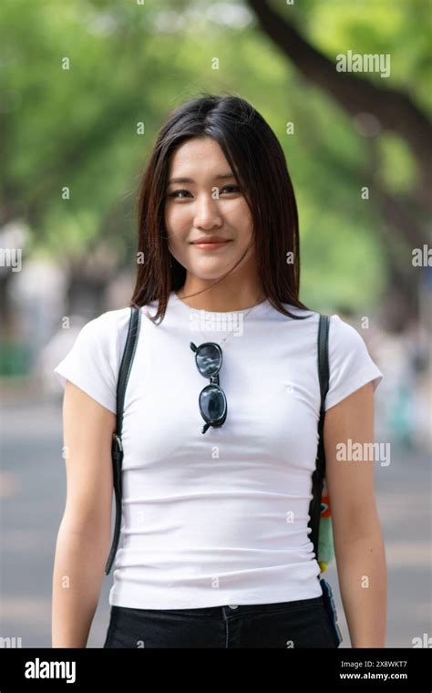 Street Portrait Of Young Beautiful Chinese Teenage Girl In The Streets