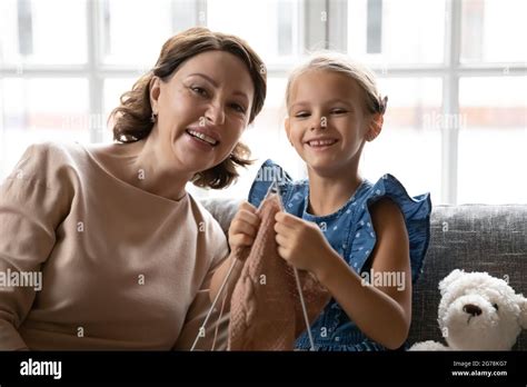 Portrait Of Smiling Mature Granny And Granddaughter Knit Stock Photo Alamy
