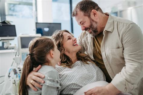 Father And Daughter Visiting Mother In Hospital After Surgery