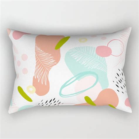 A Rectangular Pillow With An Abstract Design On It