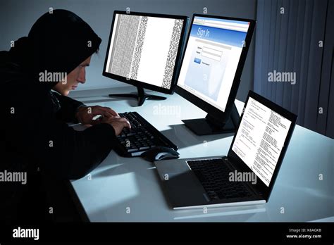 Male Hacker Using Computers To Steal Data In Office Stock Photo Alamy