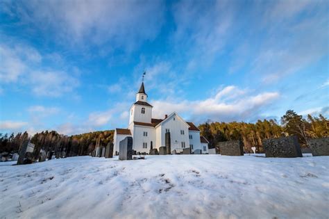 Premium Photo | Church in winter with snow and blue sky in iveland norway