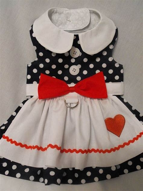 A Dress With Polka Dots And A Red Bow On The Collar Is Displayed In An