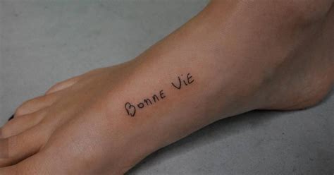 Bonne Vie Lettering Tattoo Handwritten On The Foot