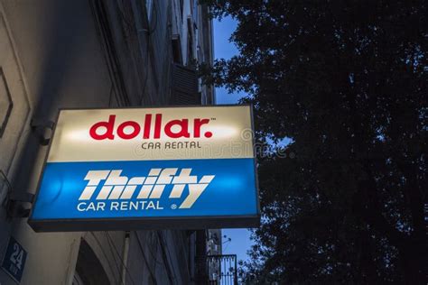 Logos Of Dollar Rent A Car And Thrifty Car Rental In Front Of Their