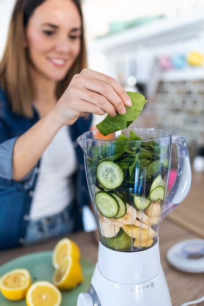 Premium Photo Shot Of Pretty Young Woman Putting Spinach In To The