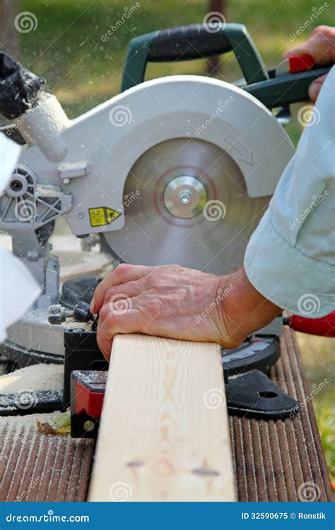 Carpenter Cutting Wooden Plank With Circular Saw Stock Image Image Of