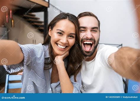 Cheerful Multiethnic Couple Taking A Selfie Stock Image Image Of