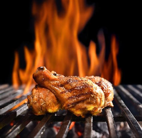 Premium Photo Grilled Chicken Legs On The Flaming Grill