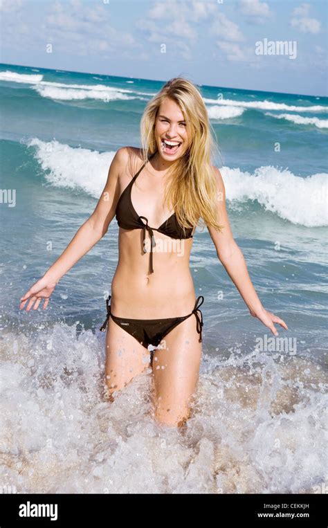 Female Very Long Blonde Hair Wearing Brown Halter Neck Bikini Stock