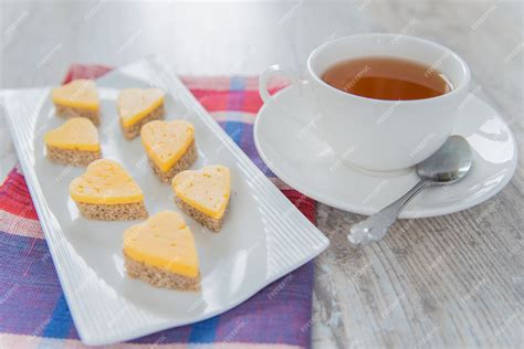 Premium Photo Heart Shaped Cheese Sandwiches On A White Plate