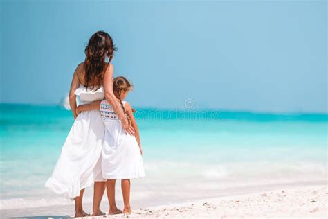 Beautiful Mother And Daughter At The Beach Enjoying Summer Vacation