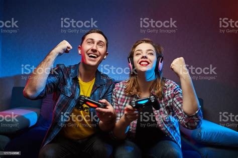 Portrait Of Crazy Playful Couple Gamers Enjoying Playing Video Games