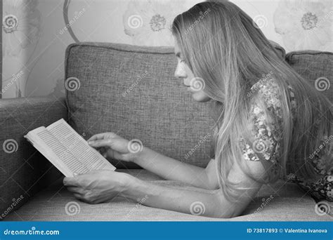 Beautiful Cute Girl Lying On The Couch And Reading A Book Stock Image Image Of Curtains Nails