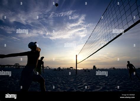 Beach volleyball match at sunset Stock Photo - Alamy