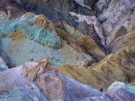 two people hiking at Artist's Palette, Death Valley national park ...