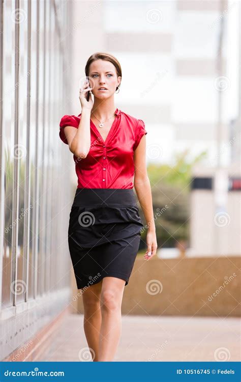 Business Woman Walking While Talking On Her Phone Stock Image Image