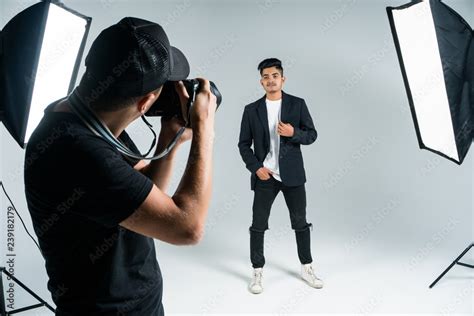 Photographer Shooting Model In Studio With Softboxes Young Man