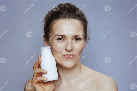 Happy Modern 40 Years Old Woman With Cosmetic Cream Jar Stock Image