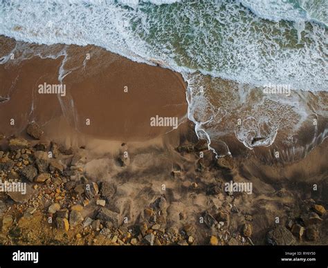 Aerial View To Ocean Waves And Rocks In A Beach Blue Water Background