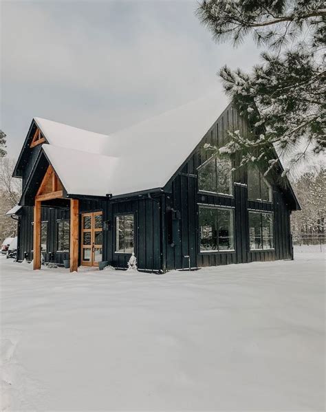 A Black House With Snow On The Ground