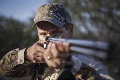 Close Up Of Man Aiming With Rifle Stock Photo