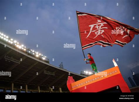 Zeng Cheng Of Guangzhou Evergrande Waves A Flag During The Champion