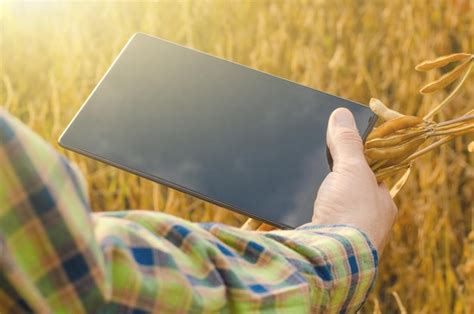 Premium Photo Farmer Using Tablet Computer For Inspecting Soy At Field