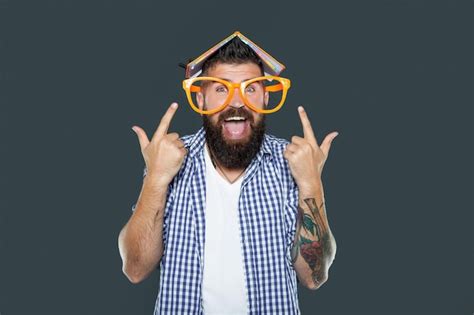 Premium Photo Funny Bearded Man In Party Glasses With Book On Head