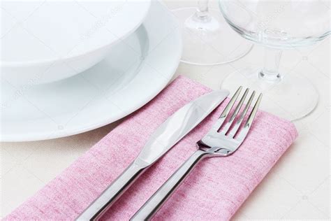 Table Setting With Fork Knife Plates And Napkin Stock Photo