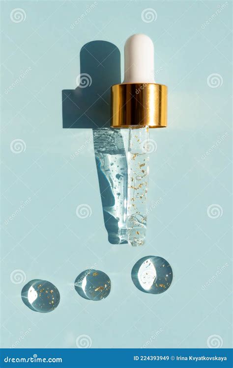 Liquid Serum And Dropper On A Blue Background Top View 24k Gold Serum