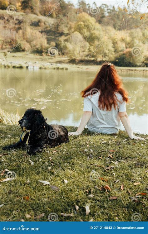 A Girl With Loose Hair Sits On The Bank Of The River Stock Image