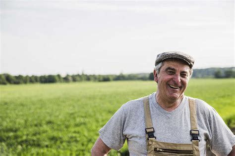 Portrait Of Smiling Farmer At A Field Stock Photo