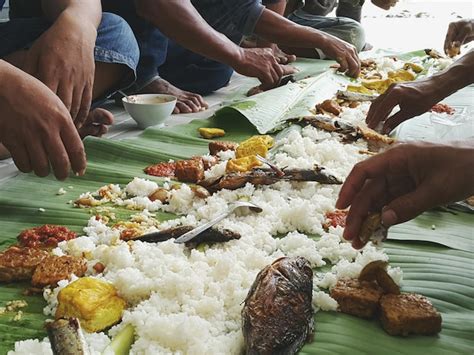 Premium Photo Cropped Image Of People Eating Food On Banana Leaves