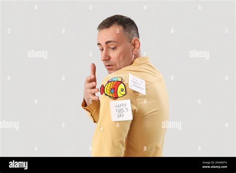 Shocked Mature Man With Sticky Papers On Grey Background April Fools