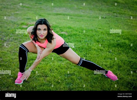 Brunette Athlete Doing Stretching Exercise In Nature Stock Photo Alamy