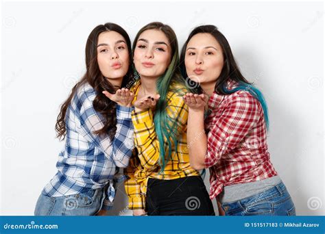 Three Young Woman With Shiny Makeup Sending Air Kiss Looking At Camera